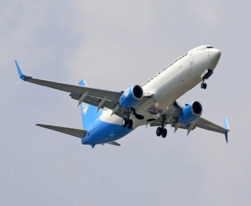airplane retracting landing gear after take off